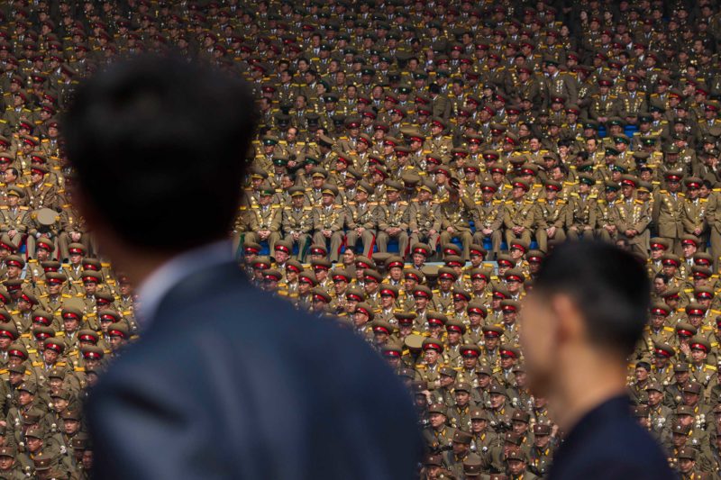 David Guttenfelder - April 15, 2012. Two North Korean officials look up at a crowd of military members seated in a stadium in Pyongyang during a mass meeting called by the Central Committee of North Korea's ruling party