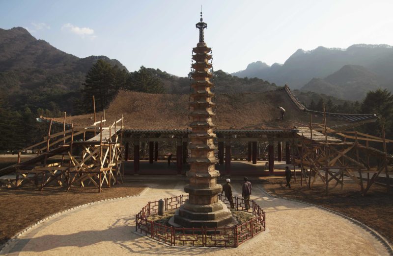 David Guttenfelder - In this April 19, 2011 photo, North Korean workers rebuild the roof of a structure at the Pohyon Temple at the foot of Mount Myohyang, North Korea