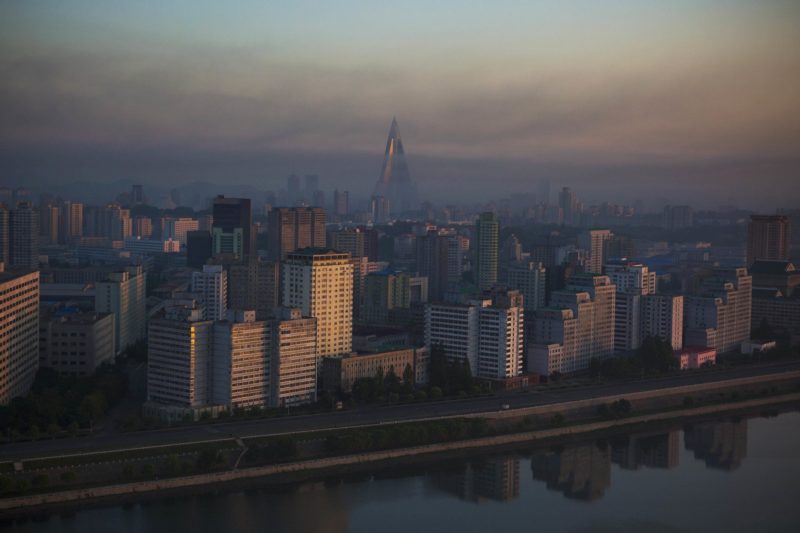 David Guttenfelder - Pyongyang at dawn from across the Taedong River. Towering above the city is the 105-story Ryugyong Hotel, under construction since 1987