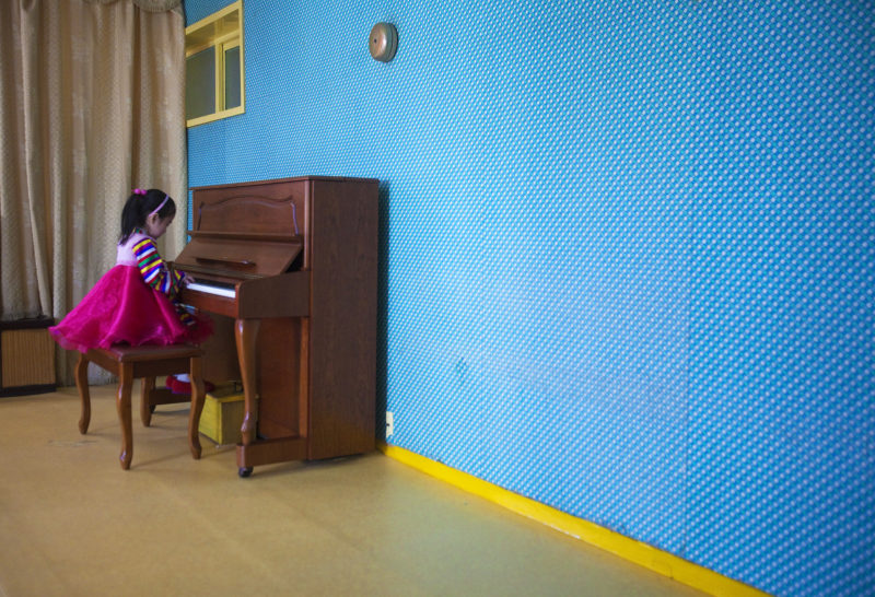 David Guttenfelder – A girl plays the piano inside the Changgwang Elementary School, in Pyongyang, North Korea