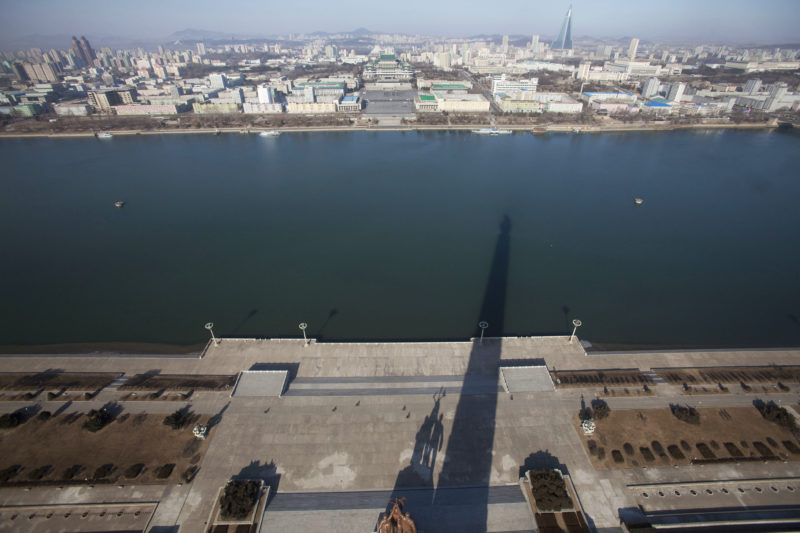 David Guttenfelder – A shadow of the 170-meter (560-foot) Juche Tower is cast over the Taedong River in Pyongyang, North Korea