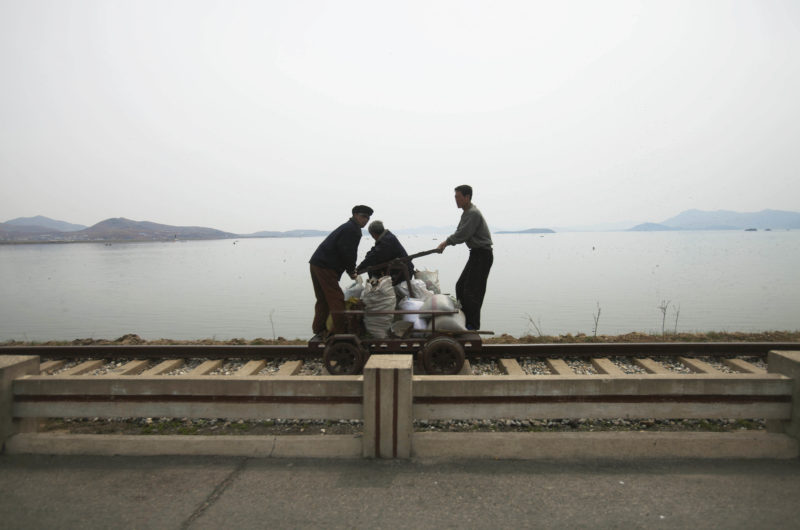 David Guttenfelder – In this April 21, 2011 photo, men operate a manual rail car on tracks running along the West Sea barrage near Nampho, North Korea