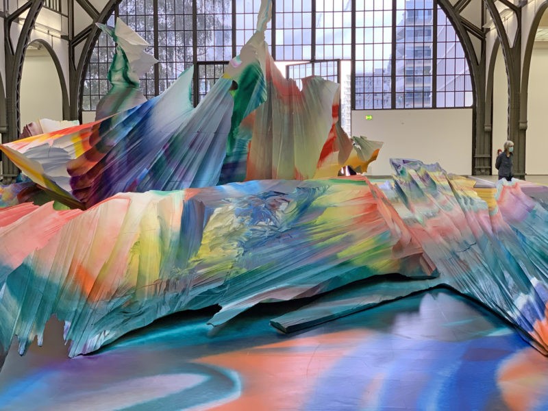 Katharina Grosse - It Wasn’t Us, 2020, acrylic on floor, polystyrene and bronze; paint on asphalt, concrete, brick and metal, 7 x 6,5 x 18,3 m, installation view, Hamburger Bahnhof, Berlin