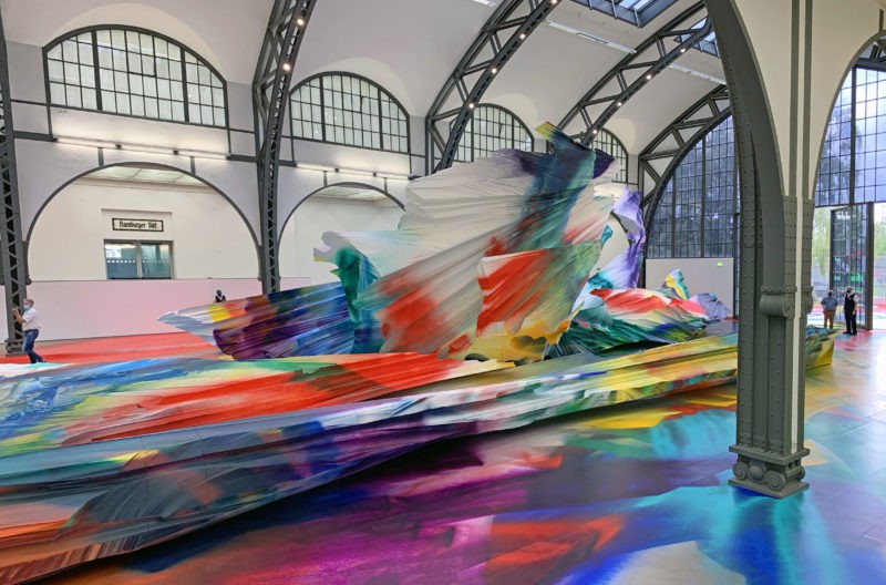 Katharina Grosse - It Wasn’t Us, 2020, acrylic on floor, polystyrene and bronze; paint on asphalt, concrete, brick and metal, 7 x 6,5 x 18,3 m, installation view, Hamburger Bahnhof, Berlin