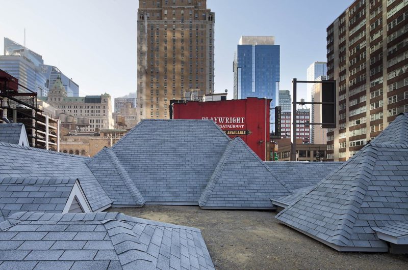 David Brooks - Desert Rooftops, 2011–12, asphalt shingled rooftops, wood, vinyl siding, metal interpretive signs, 16 x 92 x 54 feet, Times Square, New York, November 2011–February 2012.