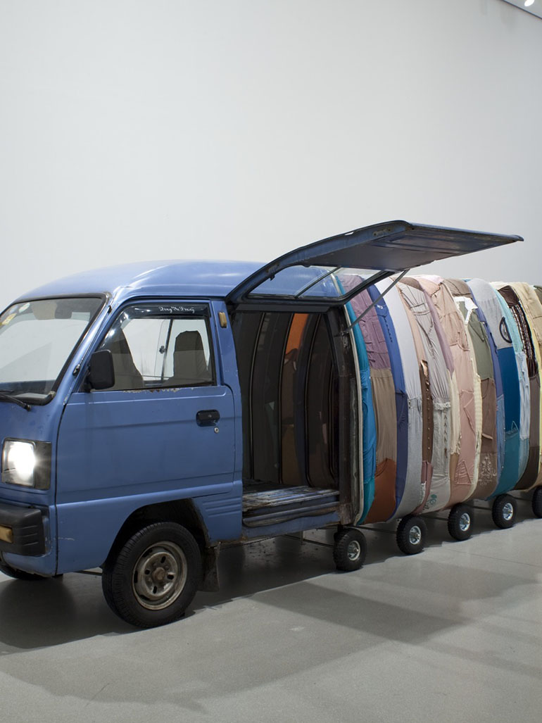 Yin-Xiuzhen-–-Collective-Subconscious-2007-Minibus-stainless-steel-used-clothes-stools-music-1420-x-140-x-190-cm-Museum-of-Modern-Art-New-York