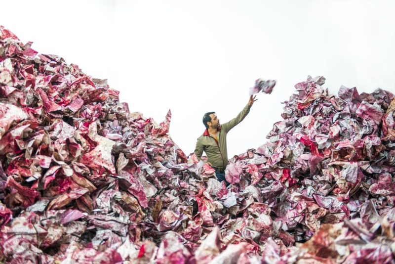 The Pakistani artist Imran Qureshi in the middle of his installation And They Still Seek the Traces of Blood, installation view, Salsali Private Museum 