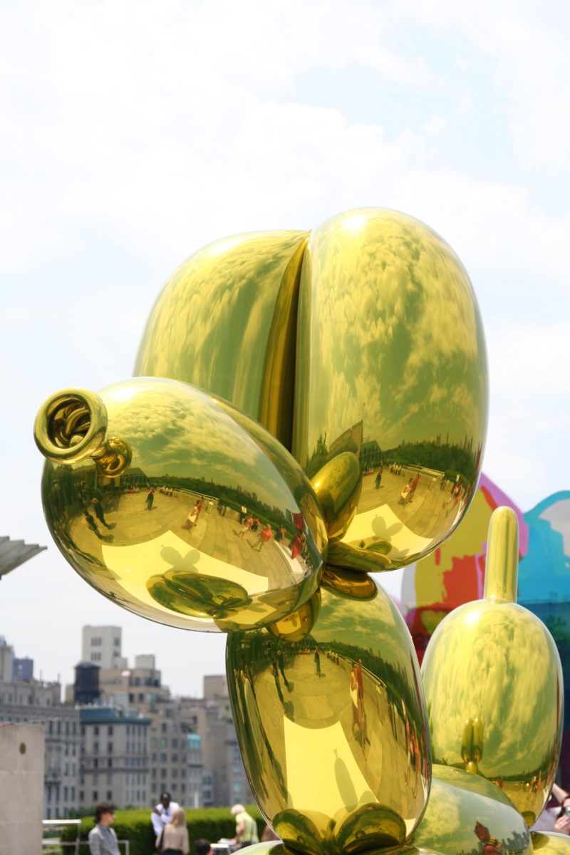 Jeff Koons - Balloon Dog (Yellow), 1994–2000, high chromium stainless steel, transparent color coating, installation view, roof of Metropolitan Museum of Art, New York City, USA, 2008