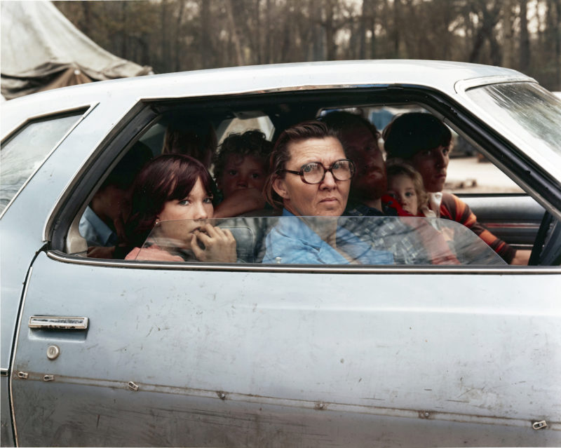 Joel Sternfeld - American Prospects, Family in a car in tent city, outside of Houston, Texas, January 1983