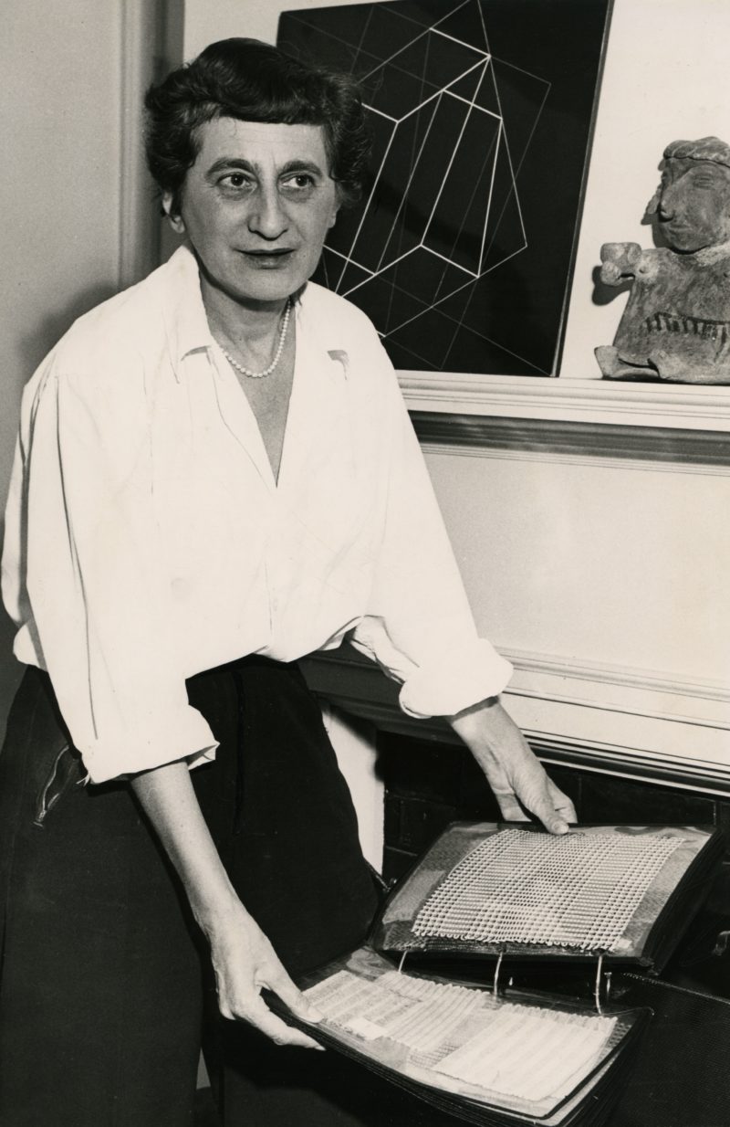 Anni Albers with textile samples in her home in New Haven, Connecticut, ca. 1950