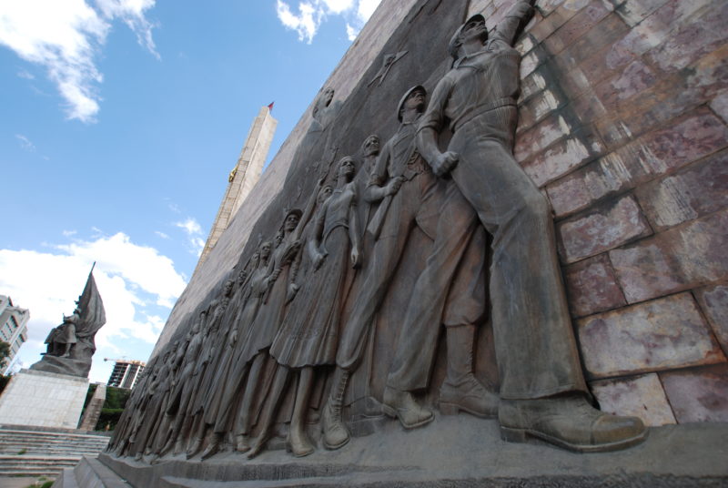There is one relief on each side, featuring the triumphant onward march of the workers. The other one shows both the former emperor Haile Selassie and Colonel Mengistu of the Derg, which overthrew him. Tiglachin Monument, 1984 – Addis Ababa, Ethiopia