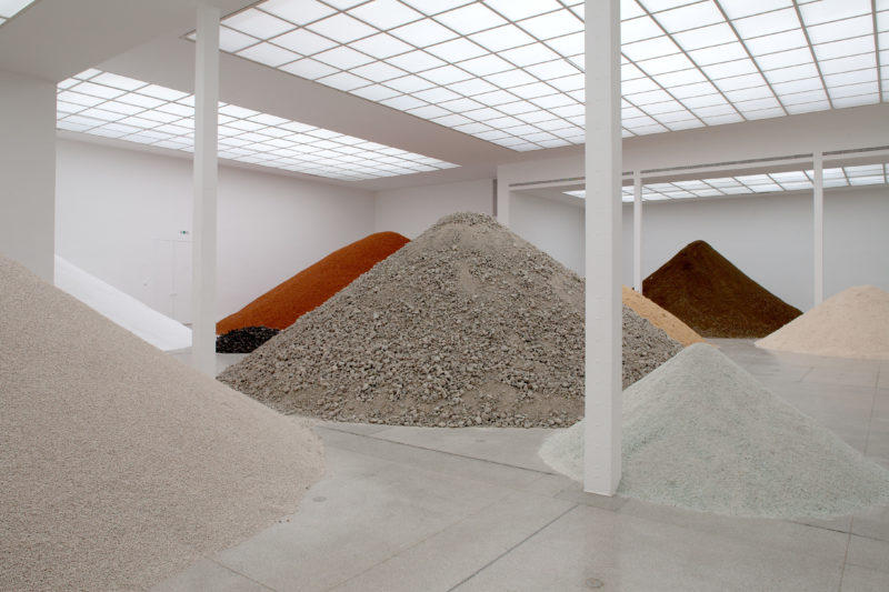 Why does Lara Almarcegui create massive piles of rubble?