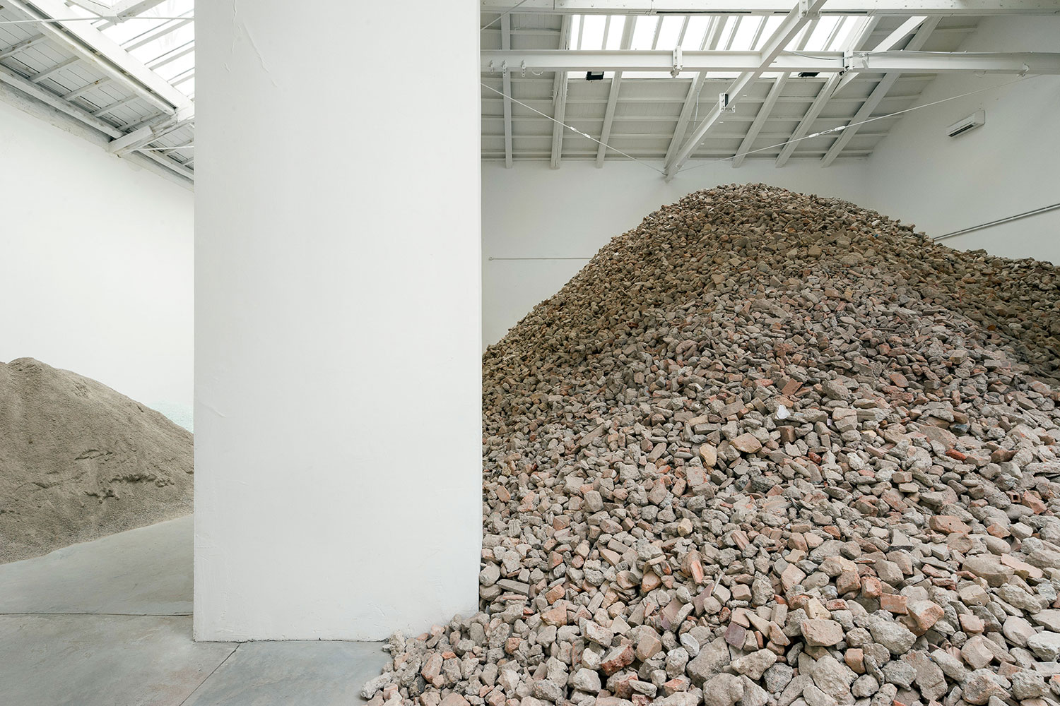Why does Lara Almarcegui create massive piles of rubble?