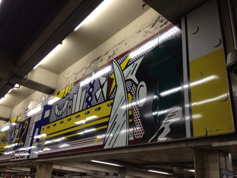 Roy Lichtenstein – Times Square Mural, 1990 (fabricated 1994; installed 2002), Porcelain enamel on steel, 16 panels, 1.85 x 16.26 m (overall), 73 x 640 1/2 inches, NYC Times Square, 42nd Street Station, New York City