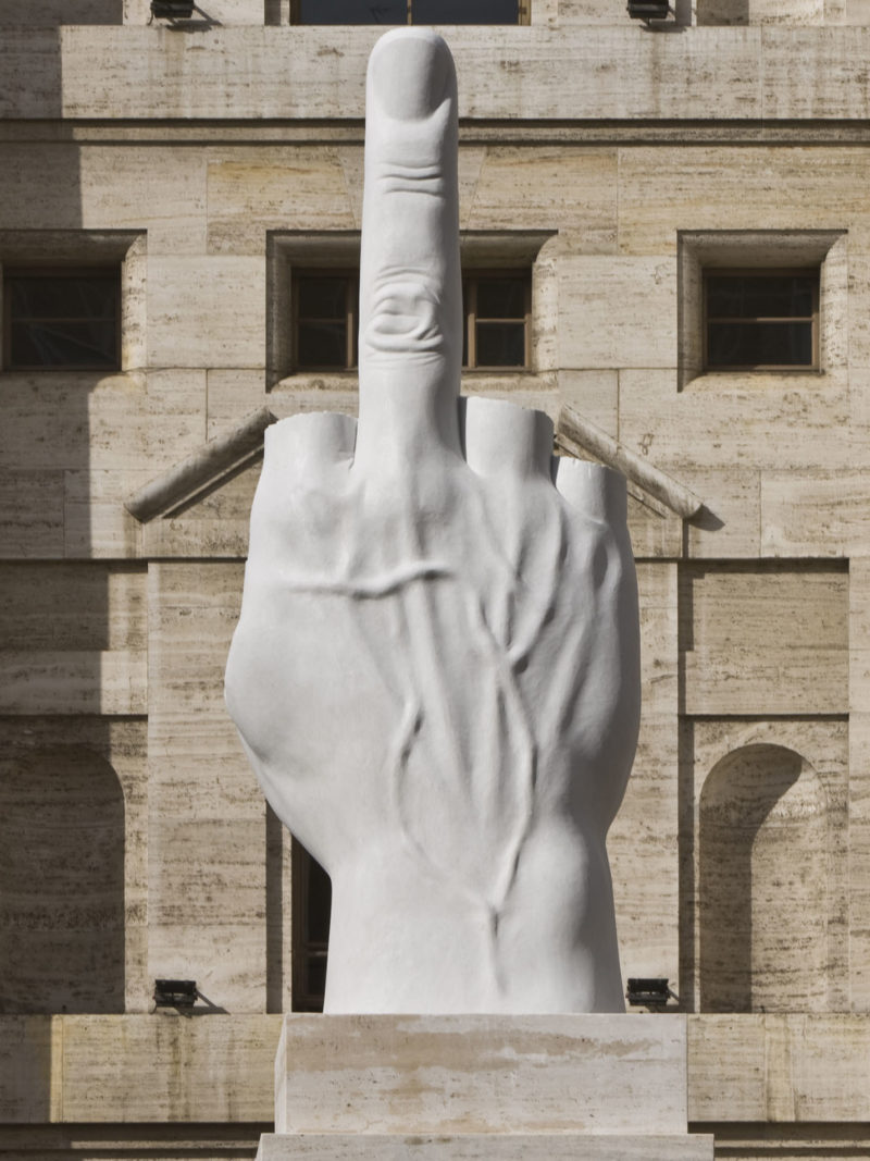 Maurizio Cattelan - L.O.V.E., 2010, White Carrara Marble, roman travertine, 1100 x 470 x 470 cm (36.1 x 15.5 x 15.5 feet), Piazza Affari Milano, Italy