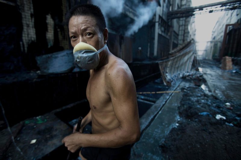 Lu Guang - In the jeans-producing village of Xintang Town, in Guangdong, workers gain the stone for grinding the denim every morning