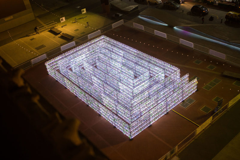 Luzinterruptus - Labyrinth of plastic waste, 2018, 15000 discarded water bottles, bags, metal, lights, 12 x 12 m, Plaza Vaticano, Buenos Aires, Argentina