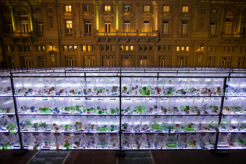 Luzinterruptus - Labyrinth of plastic waste, 2018, 15000 discarded water bottles, bags, metal, lights, 12 x 12 m, Plaza Vaticano, Buenos Aires, Argentina