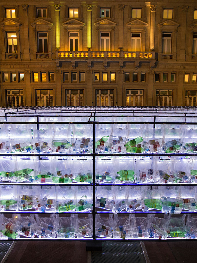 Luzinterruptus – Labyrinth of plastic waste, 2018, 15,000 discarded water bottles, bags, metal, lights, 12 x 12 m, Plaza Vaticano, Buenos Aires, Argentina