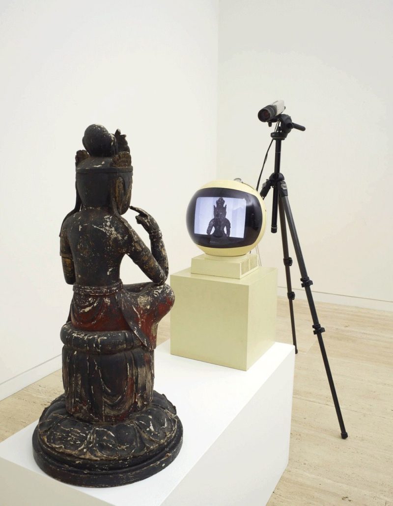 Nam June Paik - TV Buddha, 1976, television monitor, video camera, painted wooden Buddha, tripod, plinth monitor 32 x 32 x 32cm, Buddha 75 x 36 x 36 cm, John Kaldor Family Gallery, Art Gallery NSW