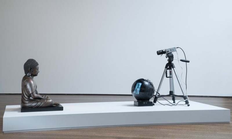 Nam June Paik - TV Buddha (Bronze Seated Buddha), 2004, Video installation with closed circuit camera, black and white JVC television, and bronze Buddha statue with permanent oil marker, 55 × 50.8 × 40.6 cm (21 11/16 × 20 × 16 in.)
