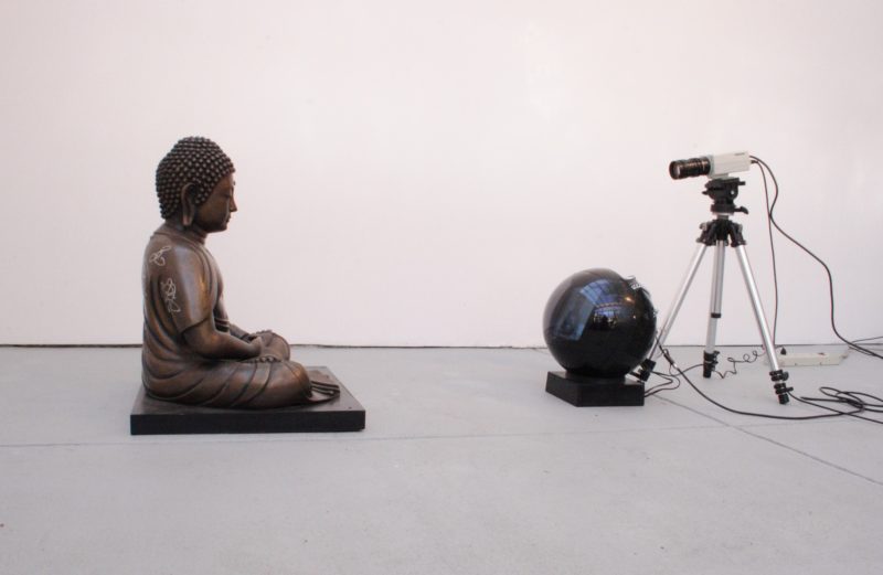 Nam June Paik - TV Buddha (Bronze Seated Buddha), 2004, Video installation with closed circuit camera, black and white JVC television, and bronze Buddha statue with permanent oil marker, 55 × 50.8 × 40.6 cm (21 11/16 × 20 × 16 in.)