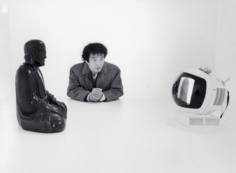 Nam June Paik and his Buddha TV 1974, pictured at Projects - Nam June Paik, Museum of Modern Art, New York, 1977, Eric Kroll