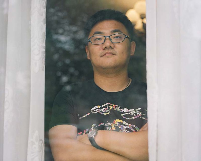 Shi Yangkun - Ge Xiaotong poses for a photo at his office in Huaxi, Jiangsu province, 2018