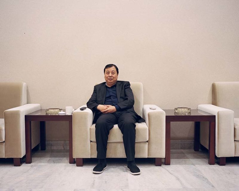 Shi Yangkun - Huaxi’s Party secretary Wu Xie’en poses for a photo at a meeting room in Huaxi, Jiangsu province, 2018