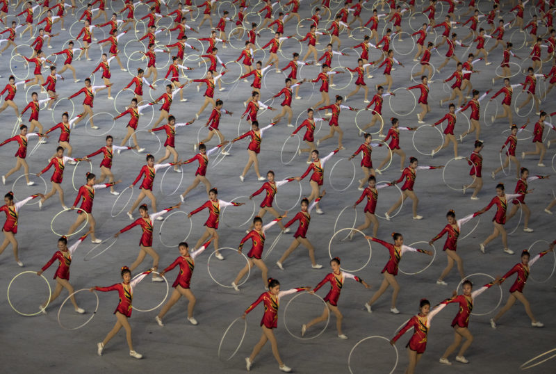 David Guttenfelder - North Korean women twirl hoops during a debut of a new mass games event to mark the 70th anniversary of the founding of the nation