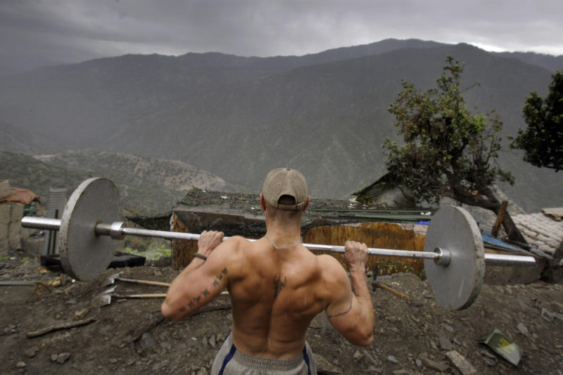 David Guttenfelder – Afghanistan - Spl. Taylor Jordan from the U.S. Army First Battalion, 26th Infantry lifts weights in the rain at his platoon's base Camp Restrepo in the Korengal Valley in Afghanistan's Kunar Province on Friday May 8, 2009 