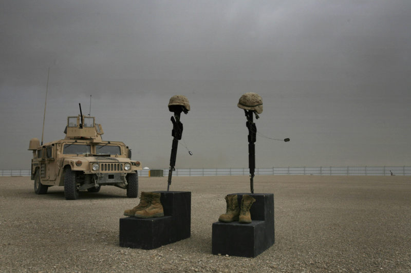 David Guttenfelder – Afghanistan - The helmets, weapons, dog tags and boots of two fallen U.S. Marines stand alone at the end of a ceremony in their honor at Camp Bastion, in southern Afghanistan Tuesday, April 22, 2008. 1st Sgt. Luke Mercardante, 35, of Athens, Ga, and Cpl. Kyle W. Wilks, 24, of Rogers, Ark. died on April 15 when their vehicle struck a roadside bomb in. Both were assigned to the Combat Logistics Batallion, 24th Marine Expeditionary Unit.