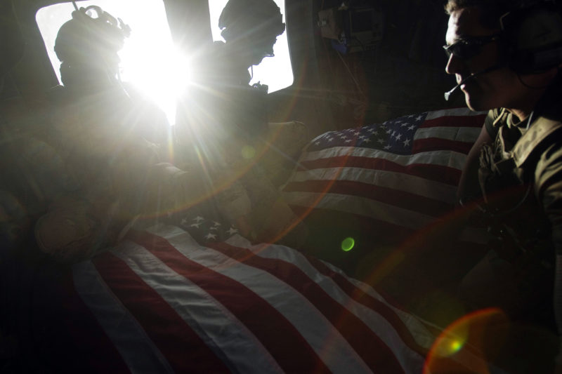 David Guttenfelder – Afghanistan - U.S. Air Force pararescuemen ride in the back of their helicopter on Oct. 10 with the flag-draped bodies of American soldiers