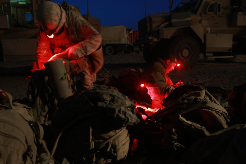 David Guttenfelder – Afghanistan - U.S. Marines from 3rd Battalion, 6th Marine Regiment read and pack their gear under red light head lamps at a forward operating campsite in Marjah in Afghanistan's Helmand province on Thursday February 18, 2010.