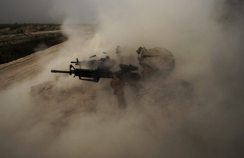 David Guttenfelder – Afghanistan - U.S. Marines, from the 24th Marine Expeditionary Unit, return fire on insurgent positions near the town of Garmser in Helmand Province, May 2, 2008. "During an air assault into Helmand River Valley, they came under rocket and small arms fire while they occupied a small farm compound. Several guys returned fire from behind the cover of a hard-packed dirt berm. Their gunfire was so intense that the recoils or concussions of their own weapons caused the berm to rise up into a huge dust cloud. The squad’s first sergeant started screaming for them to cease fire because none of them could see downrange any longer. I shot several photos. In the first few, you see at least eight or 10 Marines shooting in a line on the hill. Seconds later, when I took this photo, I could only see part of two men and one of the brass cartridges ejecting from the M-4 and up into the dust cloud."