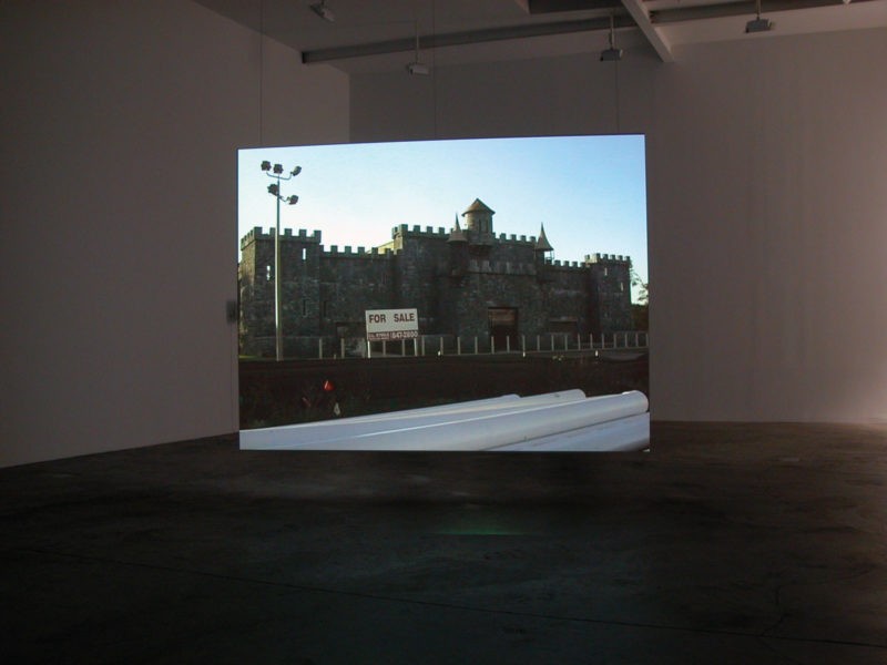 Omer Fast - Godville, 2005, Two channel video installation, 50 minutes, Installation view, Postmasters Gallery, New York