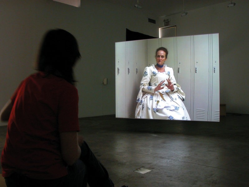 Omer Fast - Godville, 2005, Two channel video installation, 50 minutes, Installation view, Postmasters Gallery, New York