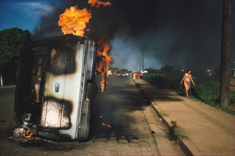 Susan Meiselas - The car of a Somoza informer burning in Managua, Nicaragua