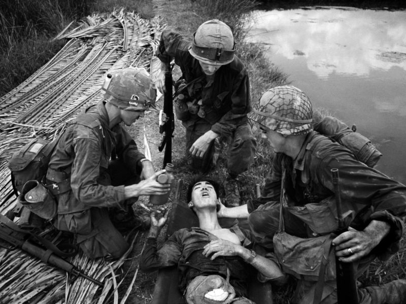 Philip Jones Griffiths - G.I.'s with Wounded Vietcong, Vietnam, 1968
