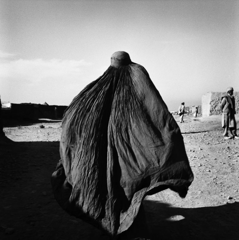Stephen Dupont - An Afghan woman in a burqa in the Shamsatoo refugee camp near the Pakistani Peshawar, Afghanistan, 2001