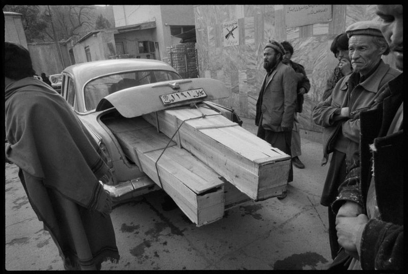 Stephen Dupont - One car, three coffins. The entrance to Jamhuriat Hospital at the time of the occupation during the Afghan Civil War, Afghanistan, 1993