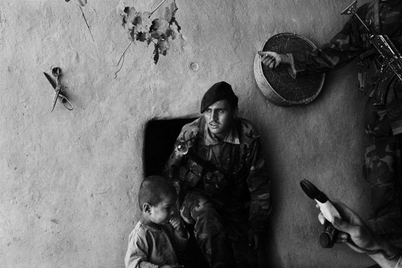 Stephen Dupont - Soldiers leave a home in Gonbaz village near Kandahar after searching for hidden Taliban fighters and guns, Afghanistan, 2005