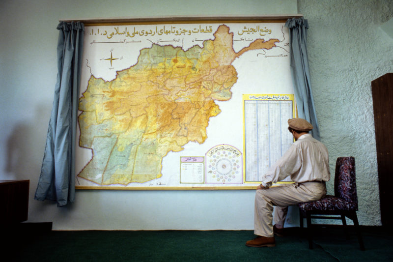 Stephen Dupont – Former Defense Minister Ahmad Shah Massoud in front of a map of the country in his office in Kabul, Afghanistan, 1995