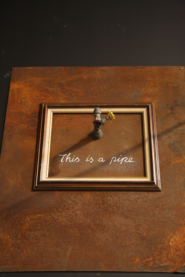Banksy - This Is A Pipe, 2011, paint, vintage frame and reclaimed metal, 69 x 80 x 29 cm (27 1:8 x 34 5:8 x 11 3:8 inches), installation view, Art in the Streets, Los Angeles MoCA, 2011
