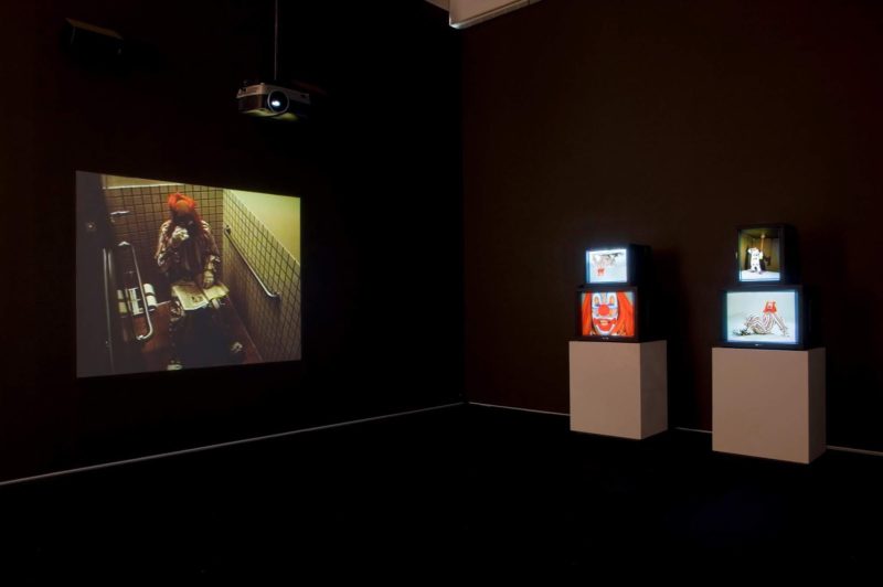 Bruce Nauman - Clown Torture, 1987, four-channel video installation, two projections, four monitors, color, sound, approx. 60 minutes, installation view, The Art Institute of Chicago/artic.edu