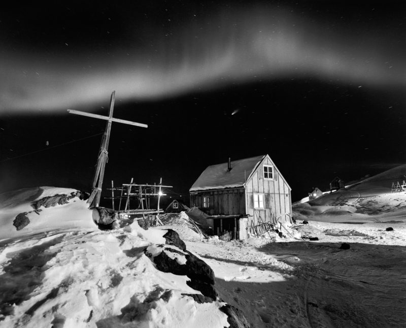 Ragnar Axelsson - Last Days of the Arctic - Comet Hale-Bop in the sky with dancing northern lights in the village of Tinniteqilaaq on the east coast of Greenland