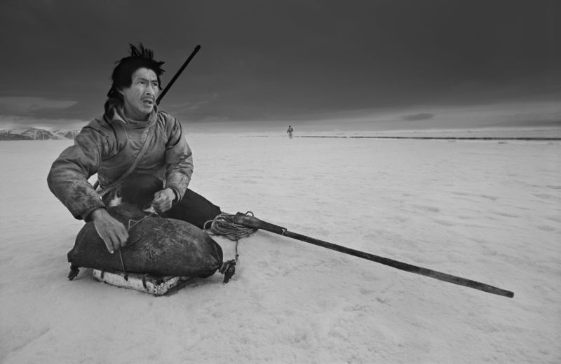 Ragnar Axelsson - Last Days of the Arctic - Hunter Ole Neylsen looking for a polar bear on the ice in Thule