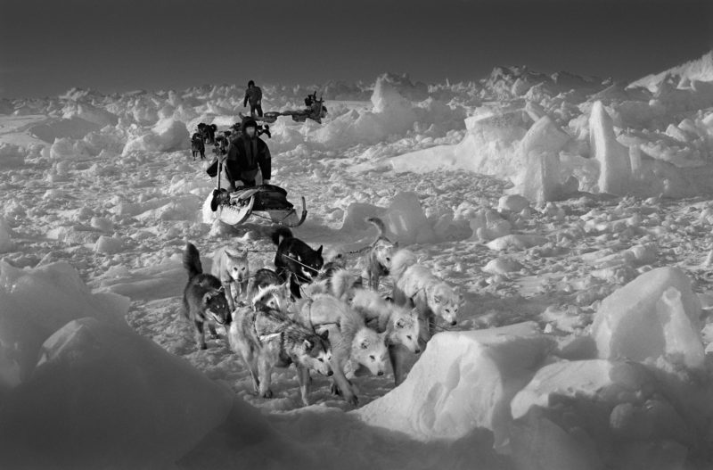 Ragnar Axelsson - Last Days of the Arctic - Polar bear hunters, Hjelmer and Isak, on rough packed ice on the east coast of Greenland. The temperature was minus 35 degrees