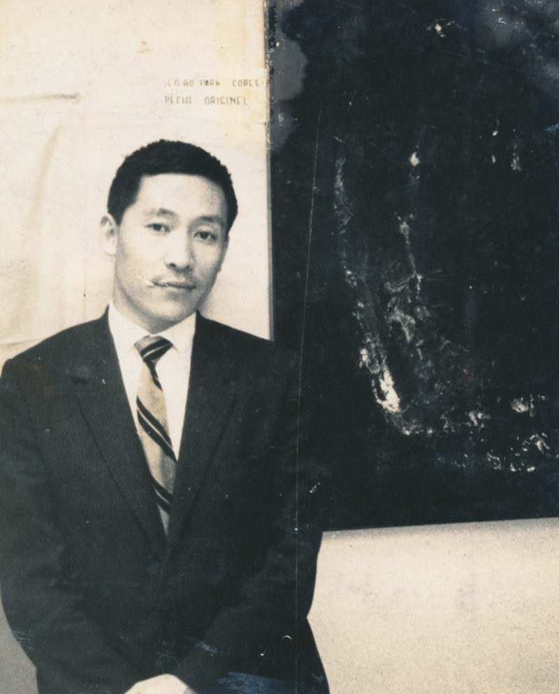 Park Seo-Bo stands in front of his painting Original Sin at the group exhibition of the Young Painters of the World in Paris