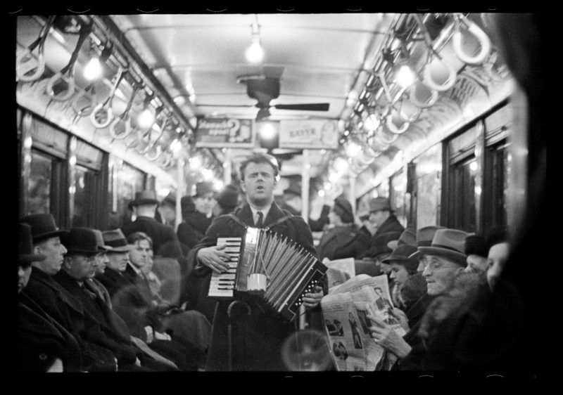 Walker Evans – View Down Subway Car with Accordionist Performing in Aisle, New York City, from Many Are Called